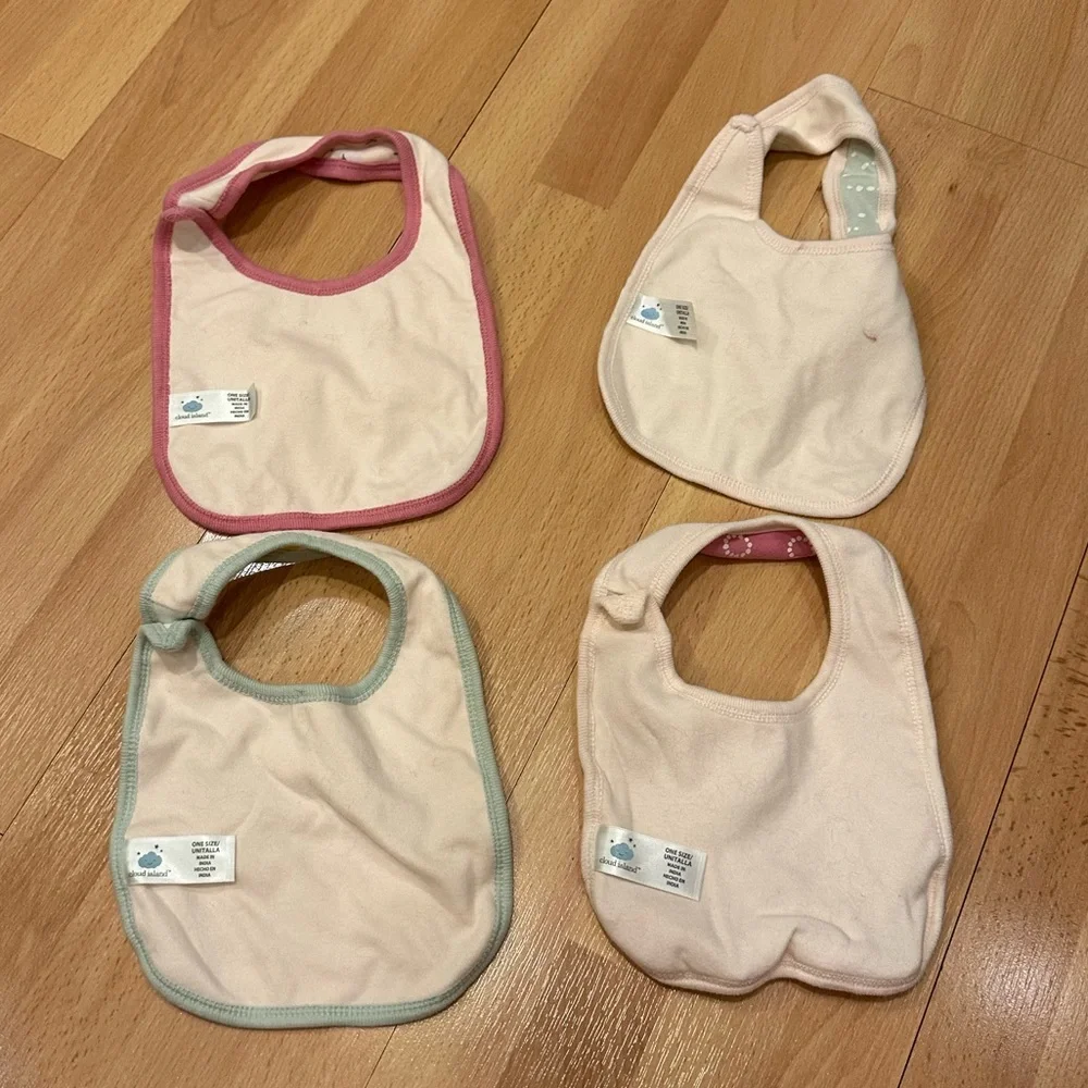 Set of four girls patterned cloud island bibs